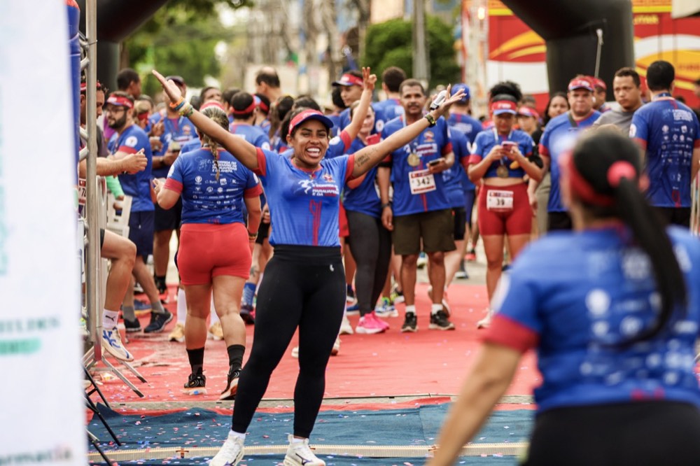 Atleta de braços abertos celebrando entre o público